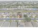Aerial view of house and neighborhood, showing street and surrounding homes at 256 Lancaster Dr, Davenport, FL 33897