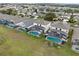 Aerial view showcasing a row of houses with pools in a residential neighborhood at 256 Lancaster Dr, Davenport, FL 33897