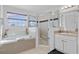 Bathroom with soaking tub, shower, and double vanity at 256 Lancaster Dr, Davenport, FL 33897
