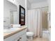 Clean bathroom with shower/tub combo, single sink vanity and linen closet at 256 Lancaster Dr, Davenport, FL 33897