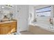 Bathroom with garden tub, double sink vanity, and window at 256 Lancaster Dr, Davenport, FL 33897