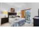 Bedroom with queen bed, access to patio, and dark wood furniture at 256 Lancaster Dr, Davenport, FL 33897