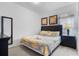 King-size bedroom with dark wood furniture and yellow bedding at 256 Lancaster Dr, Davenport, FL 33897