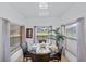 Casual dining area with glass table and chairs, offering a view of the backyard at 256 Lancaster Dr, Davenport, FL 33897