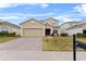 Two-story house with a brick driveway and landscaped lawn at 256 Lancaster Dr, Davenport, FL 33897