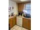 Kitchen features countertops, wood cabinets and white dishwasher at 2681 Robin Ave, Kissimmee, FL 34744