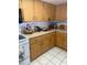 Traditional kitchen features wood cabinets, light countertops, and tiled floors at 2681 Robin Ave, Kissimmee, FL 34744