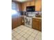 Kitchen features wood cabinets, light countertops, and a white oven at 2681 Robin Ave, Kissimmee, FL 34744