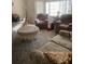 Comfortable living room featuring plush seating, a lace covered table, and natural light from the windows at 2681 Robin Ave, Kissimmee, FL 34744