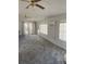 Bright living room with ceiling fans, large windows, and neutral walls for customizable style at 2681 Robin Ave, Kissimmee, FL 34744