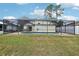 Well-maintained backyard featuring an enclosed pool, perfect for enjoying sunny days and outdoor activities at 2993 Stillwater Dr, Kissimmee, FL 34743