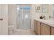 Bathroom with a white double vanity, a large mirror, and glass door shower featuring blue sky at 2993 Stillwater Dr, Kissimmee, FL 34743