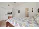 Bedroom with white walls, ceiling fan, a patterned comforter, and an en-suite bathroom with glass shower at 2993 Stillwater Dr, Kissimmee, FL 34743