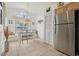 Charming breakfast nook featuring a window seat, tiled floors, stainless steel refrigerator, and ample natural light at 2993 Stillwater Dr, Kissimmee, FL 34743