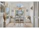 Bright breakfast nook features a window seat, large windows, tile flooring, and decorative lighting for a cozy ambiance at 2993 Stillwater Dr, Kissimmee, FL 34743