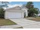 Inviting one-story home with a two-car garage and manicured front yard at 2993 Stillwater Dr, Kissimmee, FL 34743