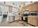 Spacious kitchen offers stainless steel appliances, tiled flooring, a breakfast bar, and a view into the living area for easy entertaining at 2993 Stillwater Dr, Kissimmee, FL 34743