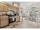 Bright kitchen featuring wood cabinetry, stainless steel appliances, and a cozy breakfast nook, creating a functional and inviting space at 2993 Stillwater Dr, Kissimmee, FL 34743