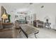 Spacious living room with modern wood-look floors, a ceiling fan, and neutral wall color at 2993 Stillwater Dr, Kissimmee, FL 34743