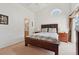 Comfortable main bedroom with ensuite bathroom and a bright window with view of the pool area at 2993 Stillwater Dr, Kissimmee, FL 34743