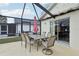 Covered patio with outdoor dining set perfect for enjoying meals, with access to the house at 2993 Stillwater Dr, Kissimmee, FL 34743