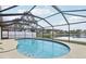 Screened-in pool overlooking a serene lake, offering a peaceful outdoor experience in the backyard at 2993 Stillwater Dr, Kissimmee, FL 34743