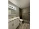 Modern bathroom with gray tile shower and white vanity at 3036 Parkway Blvd # 104, Kissimmee, FL 34747
