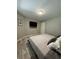 Bright bedroom with a large bed, wood-look floors, and a wall-mounted TV at 3036 Parkway Blvd # 104, Kissimmee, FL 34747