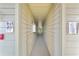 Well-lit hallway with carpeted floors and neutral walls at 3036 Parkway Blvd # 104, Kissimmee, FL 34747
