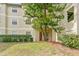 Condo building with a lush green lawn and landscaping at 3036 Parkway Blvd # 104, Kissimmee, FL 34747