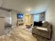 Spacious living room featuring a neutral color palette and wood-look tile floors at 3036 Parkway Blvd # 104, Kissimmee, FL 34747