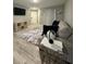 Bright living room featuring wood-look tile floors and comfy seating at 3036 Parkway Blvd # 104, Kissimmee, FL 34747