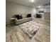 Living room with gray sofa, patterned rug, and wood-look floors at 3036 Parkway Blvd # 104, Kissimmee, FL 34747
