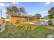 Backyard view of the house with a pool, patio, and lawn at 306 Boger N Blvd, Lakeland, FL 33803