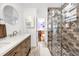 Modern bathroom features a glass shower, designer tile, and a vessel sink with wood cabinets at 306 Boger N Blvd, Lakeland, FL 33803