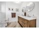 Bathroom with double vanity, modern light fixtures, and white walls at 306 Boger N Blvd, Lakeland, FL 33803