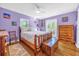 Bedroom with wood floors, a log bed frame, and a dresser; lavender walls at 306 Boger N Blvd, Lakeland, FL 33803
