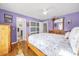 Lavender bedroom with wood floors, a log bed frame, and sliding glass doors at 306 Boger N Blvd, Lakeland, FL 33803