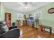 A room with hardwood floors, boxes, and light green painted walls at 306 Boger N Blvd, Lakeland, FL 33803