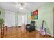 Relaxing bedroom with hardwood floors, comfortable chair, and guitar at 306 Boger N Blvd, Lakeland, FL 33803