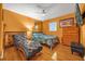 Bedroom with hardwood floors, dresser, and a comfy bed at 306 Boger N Blvd, Lakeland, FL 33803