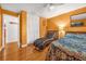Bright bedroom with hardwood floors, a chaise lounge, and natural light from the open door at 306 Boger N Blvd, Lakeland, FL 33803