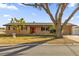Brick ranch house with a large tree and attached garage at 306 Boger N Blvd, Lakeland, FL 33803
