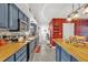 A kitchen featuring stainless appliances, blue cabinets, butcher block counters, and a red brick backsplash at 306 Boger N Blvd, Lakeland, FL 33803