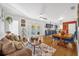 Open living room and kitchen with hardwood floors, a brown couch, and blue cabinets at 306 Boger N Blvd, Lakeland, FL 33803