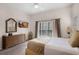 Bedroom with a queen bed, dresser, and balcony access at 312 Lucaya Loop # B5/U312, Davenport, FL 33897