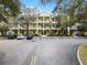 Building exterior showcasing a yellow three-story building with parking at 312 Lucaya Loop # B5/U312, Davenport, FL 33897