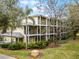 Multi-story building with screened balconies and lush landscaping at 312 Lucaya Loop # B5/U312, Davenport, FL 33897