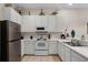 Modern kitchen featuring white cabinets and stainless steel appliances at 312 Lucaya Loop # B5/U312, Davenport, FL 33897