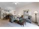 Living room with gray sofas, coffee table, and view of kitchen at 312 Lucaya Loop # B5/U312, Davenport, FL 33897